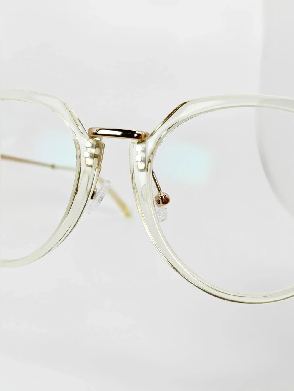 Tamara. Clear Round Frame Glasses. All Gold Accents are Metal.